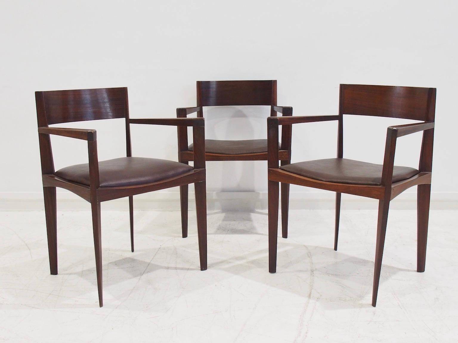 Set of six Italian wooden dining chairs in dark brown faux leather.