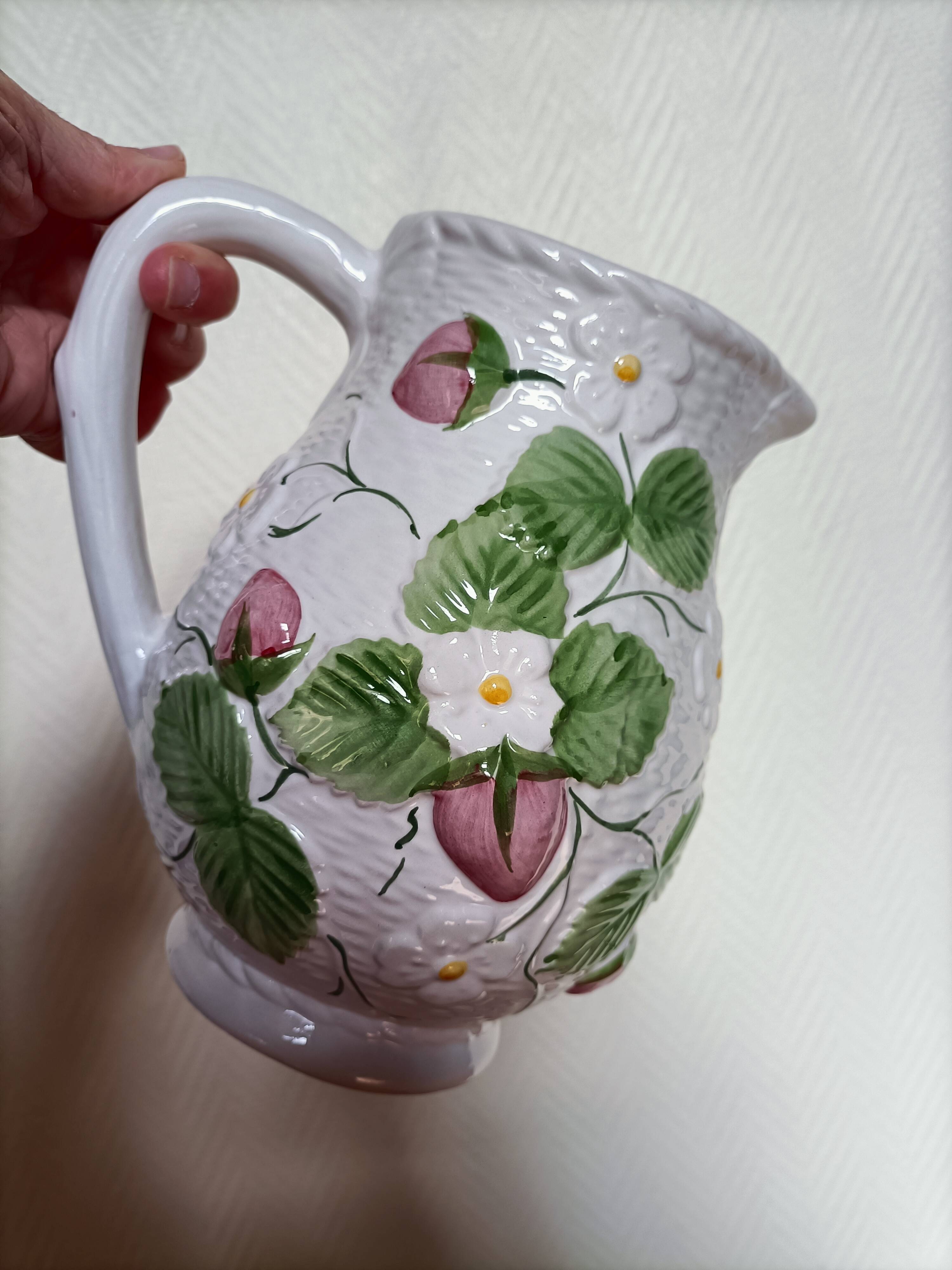 Barbotine pitcher with pastel flower decoration