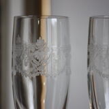 2 crystal champagne flutes of engraved arches