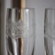 2 crystal champagne flutes of engraved arches