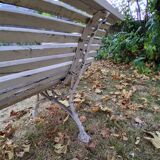 Pair of antique wooden slatted benches with wrought iron legs.