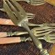 Dessert forks in brass and Bakelite in their case.