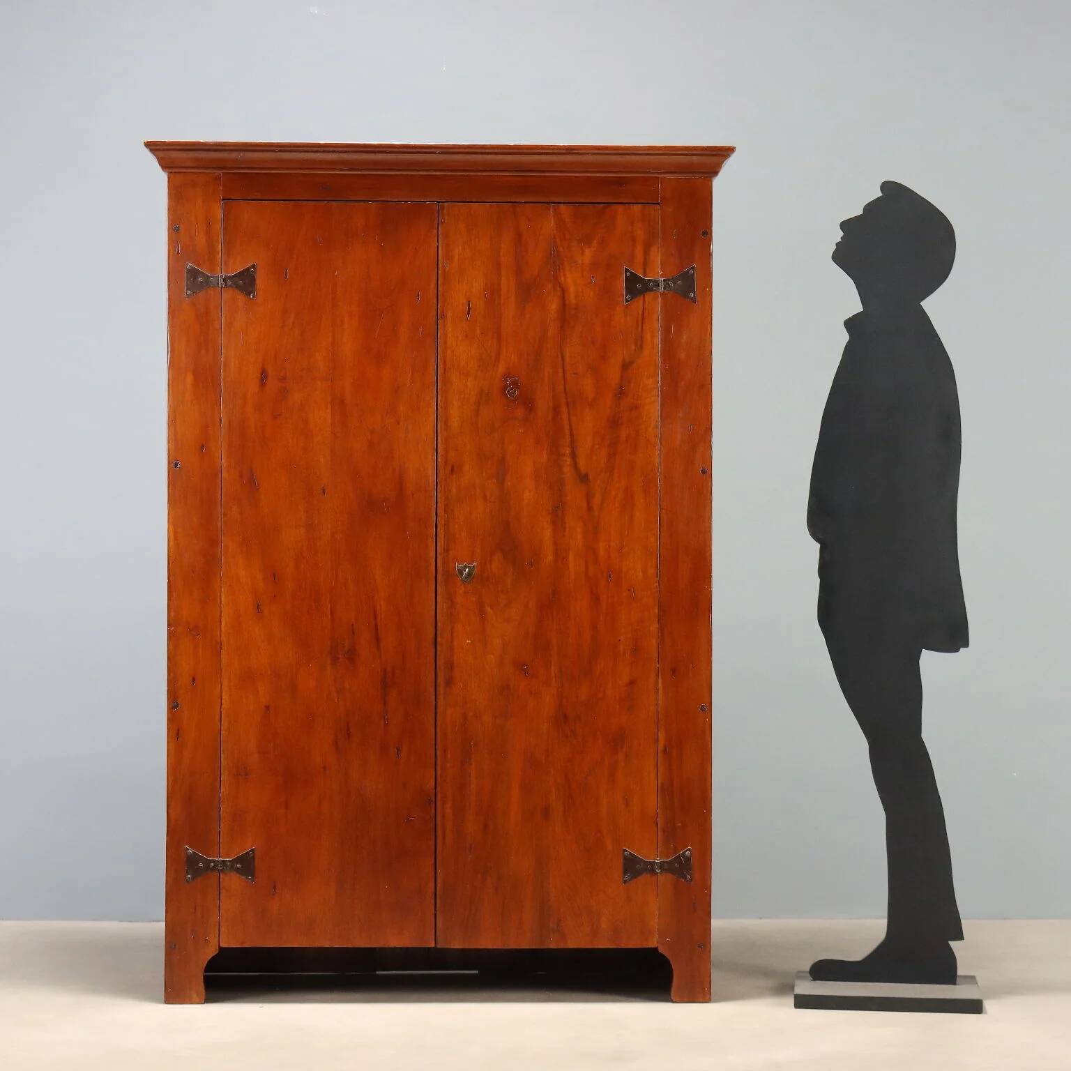 Vintage walnut wardrobe with exposed hardware.