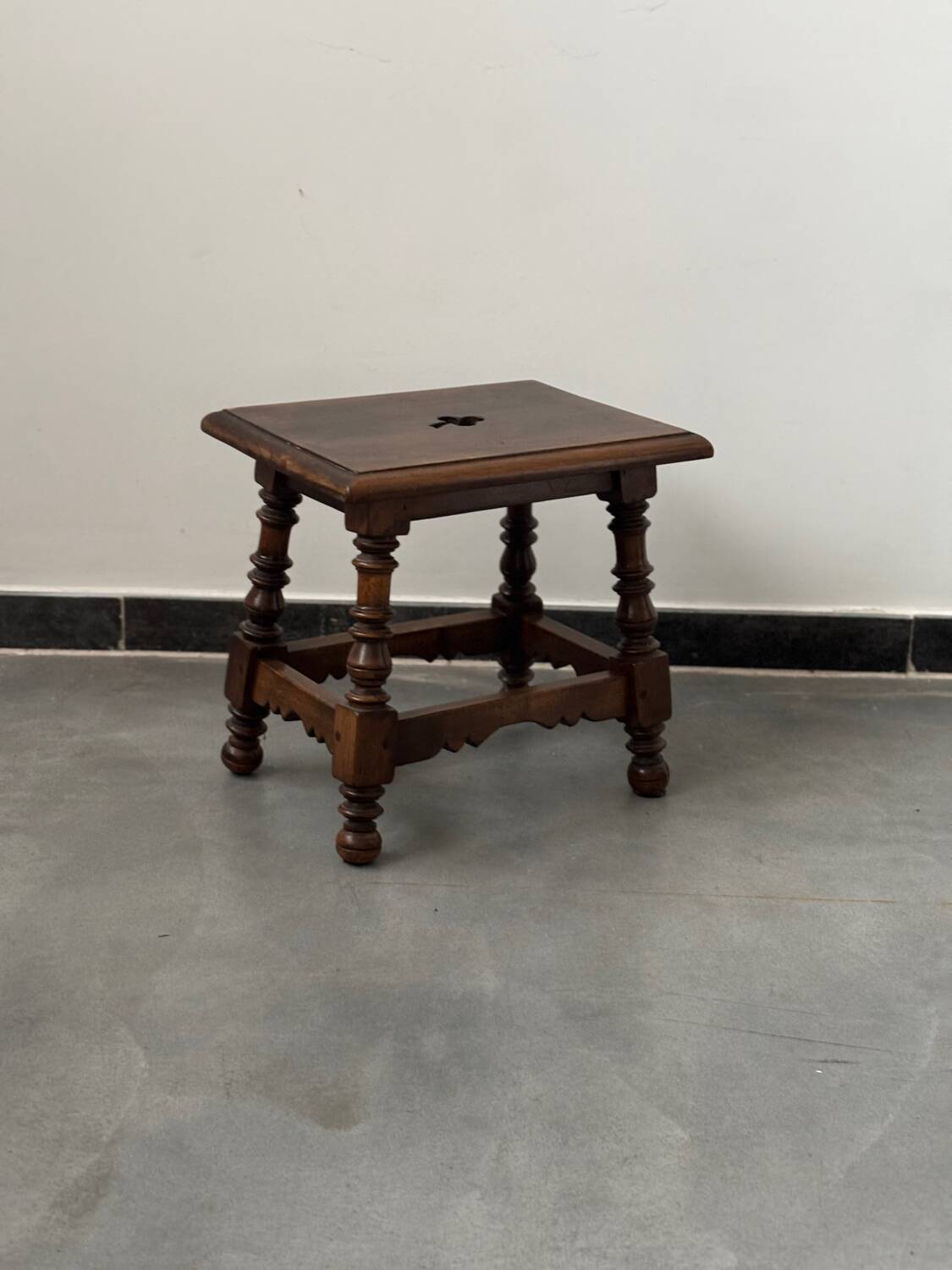 Small antique wooden stool with an openwork pattern.