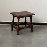 Small antique wooden stool with an openwork pattern.