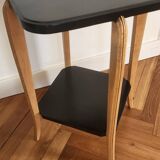 Black lacquered wooden side table with offset tops.