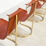 Set of four leather and brass Italian dining chairs