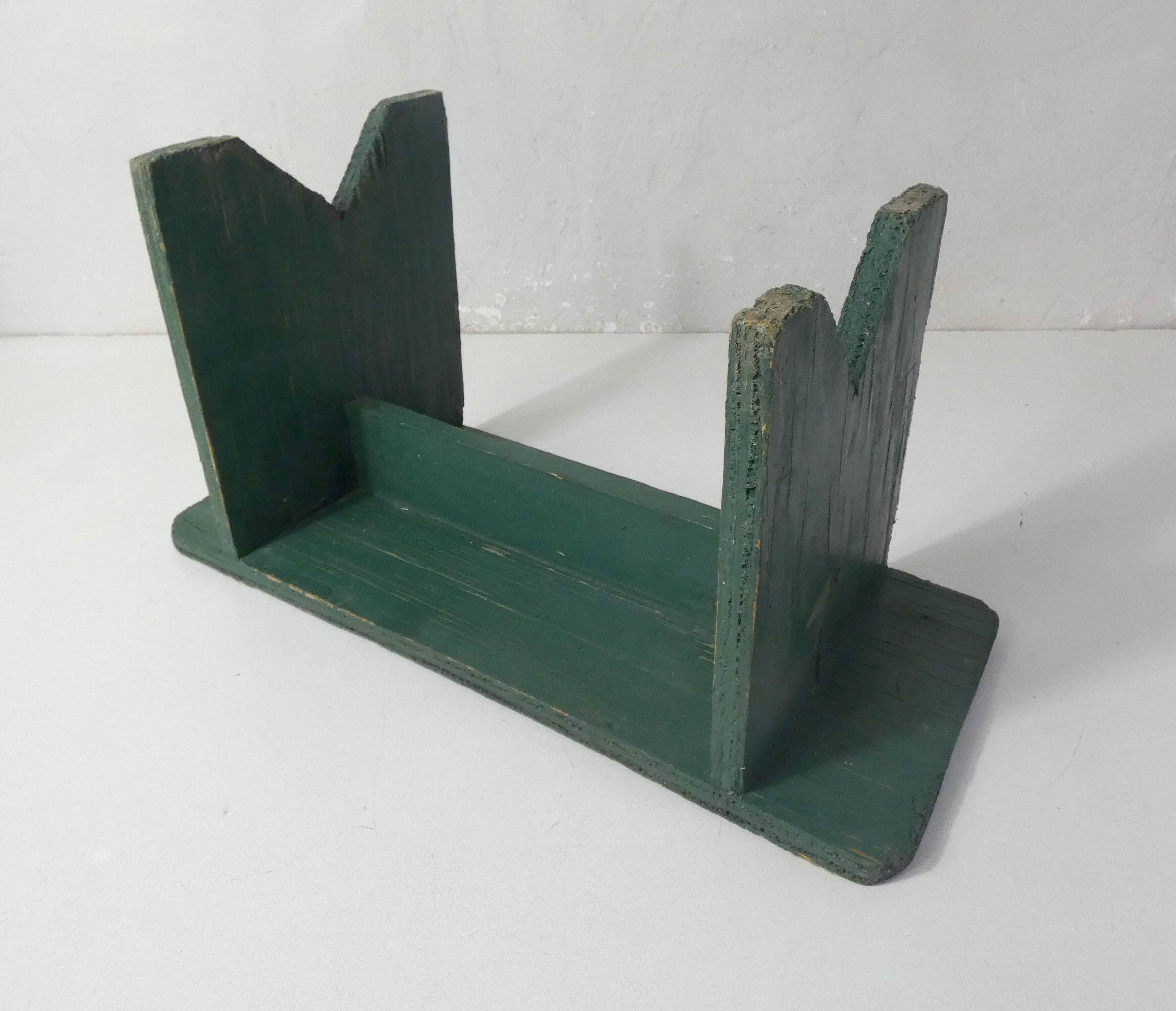Old small wooden bench with green foot