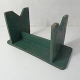 Old small wooden bench with green foot