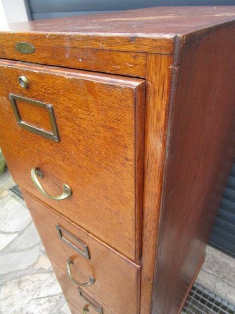 Antique oak filing cabinet with 4 drawers.