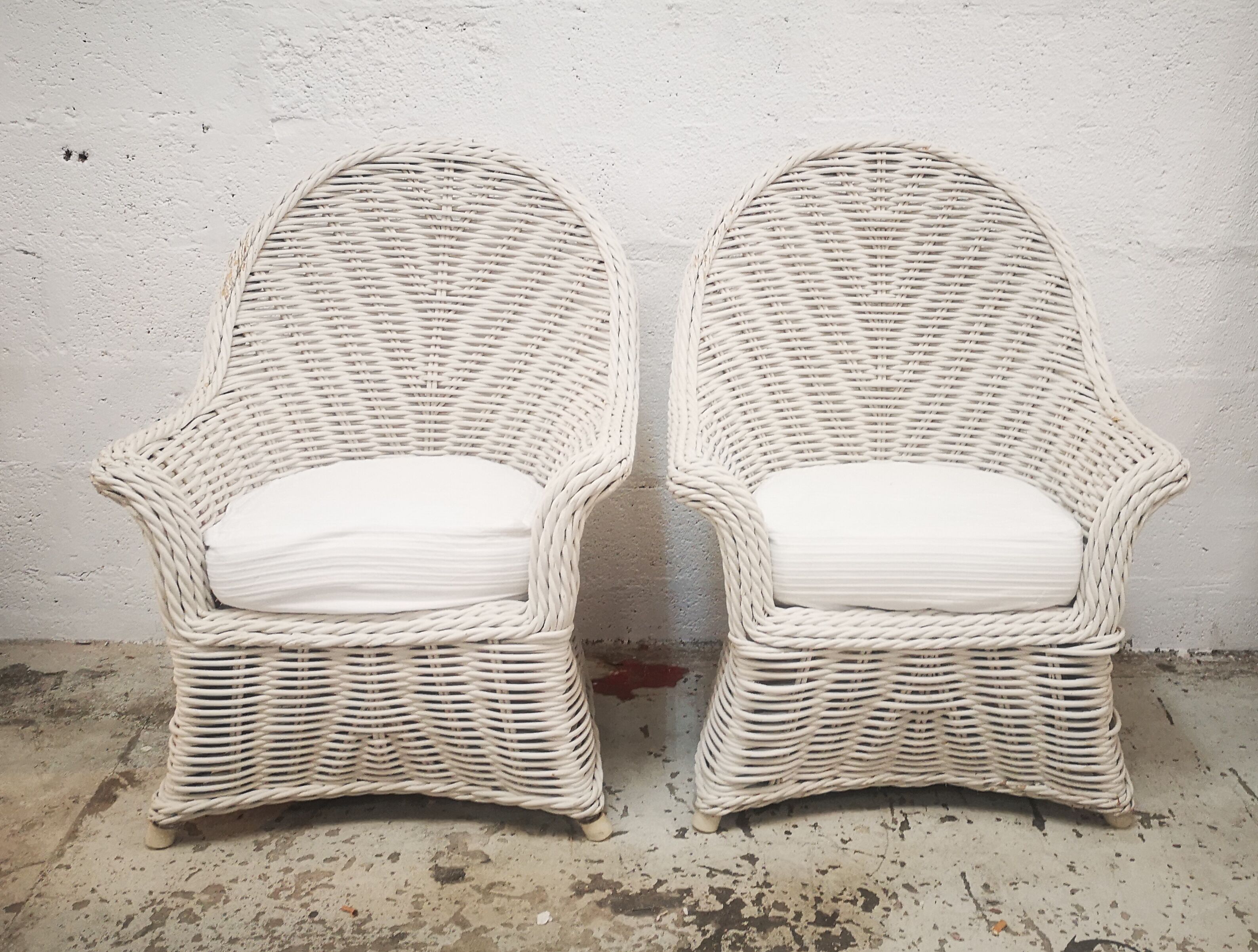 Pair of white rattan armchairs