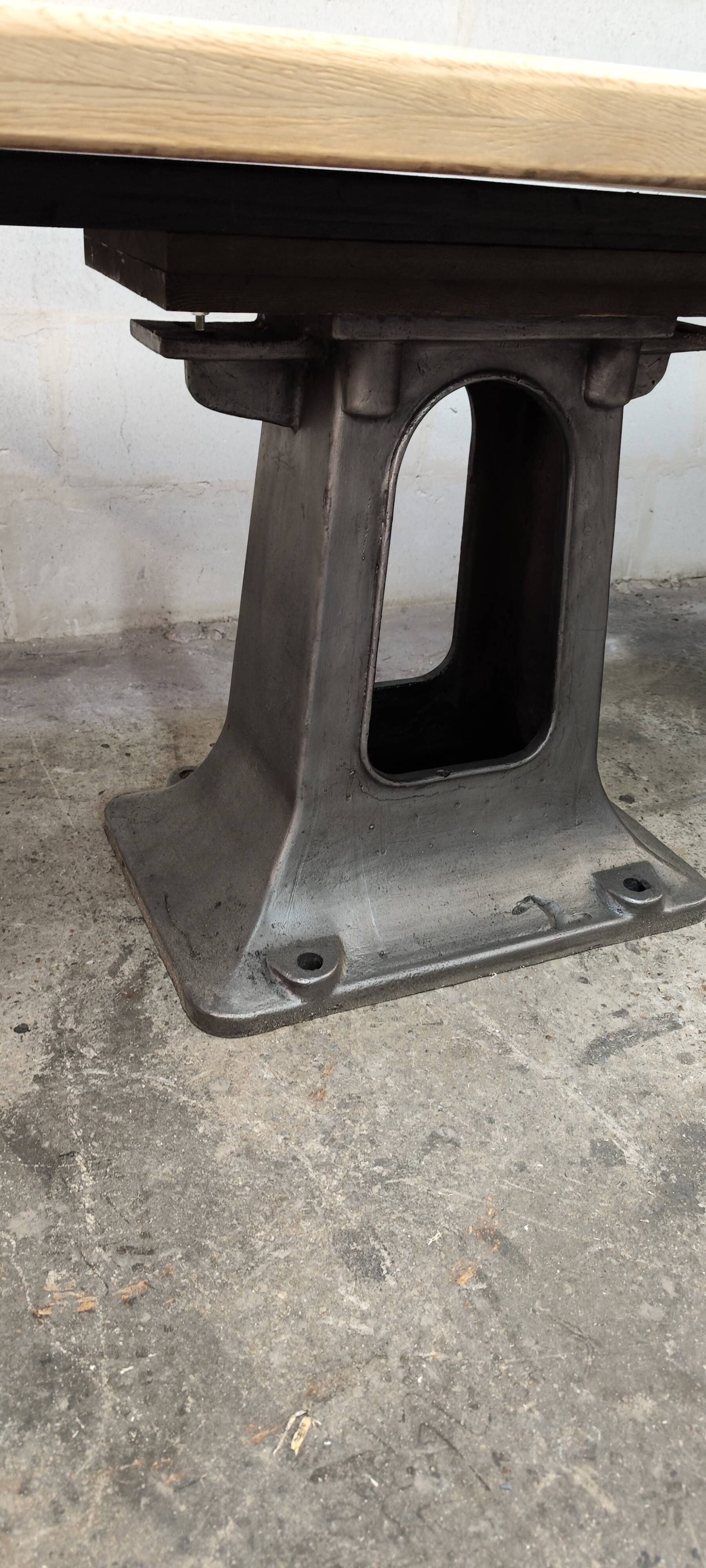 Industrial table with oak top and cast iron central leg