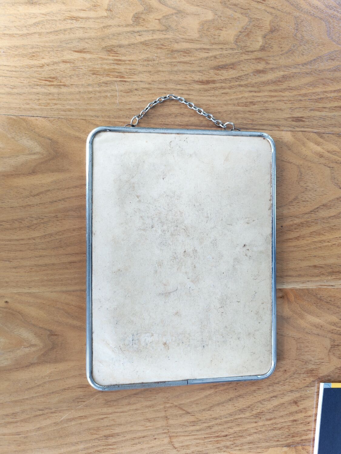 Vintage barber mirror with chain.