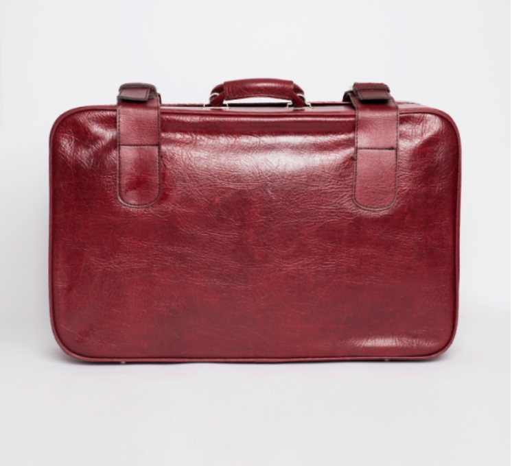 Red faux leather suitcase