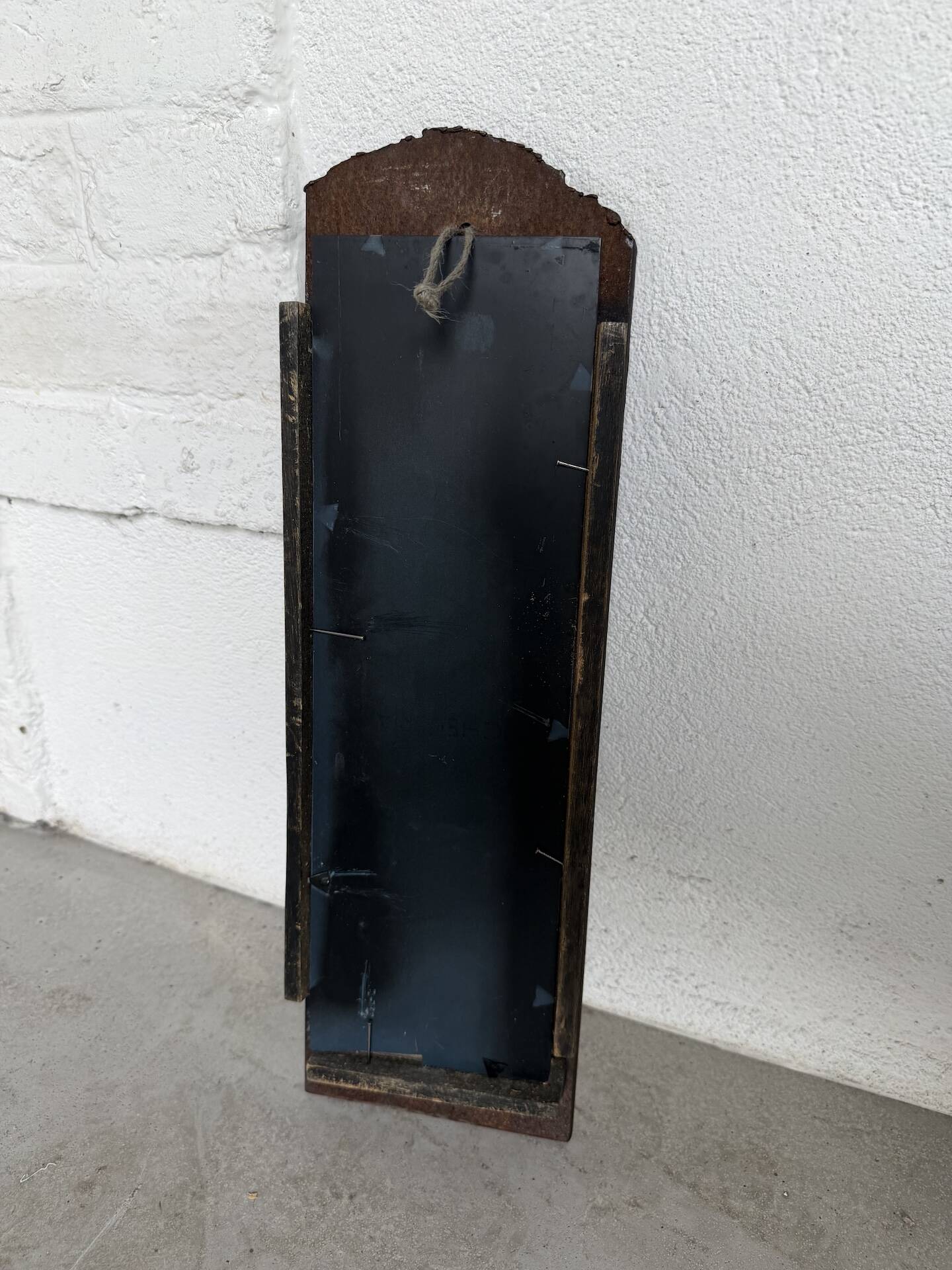 Brutalist hammered mirror, free-form, patinated metal.