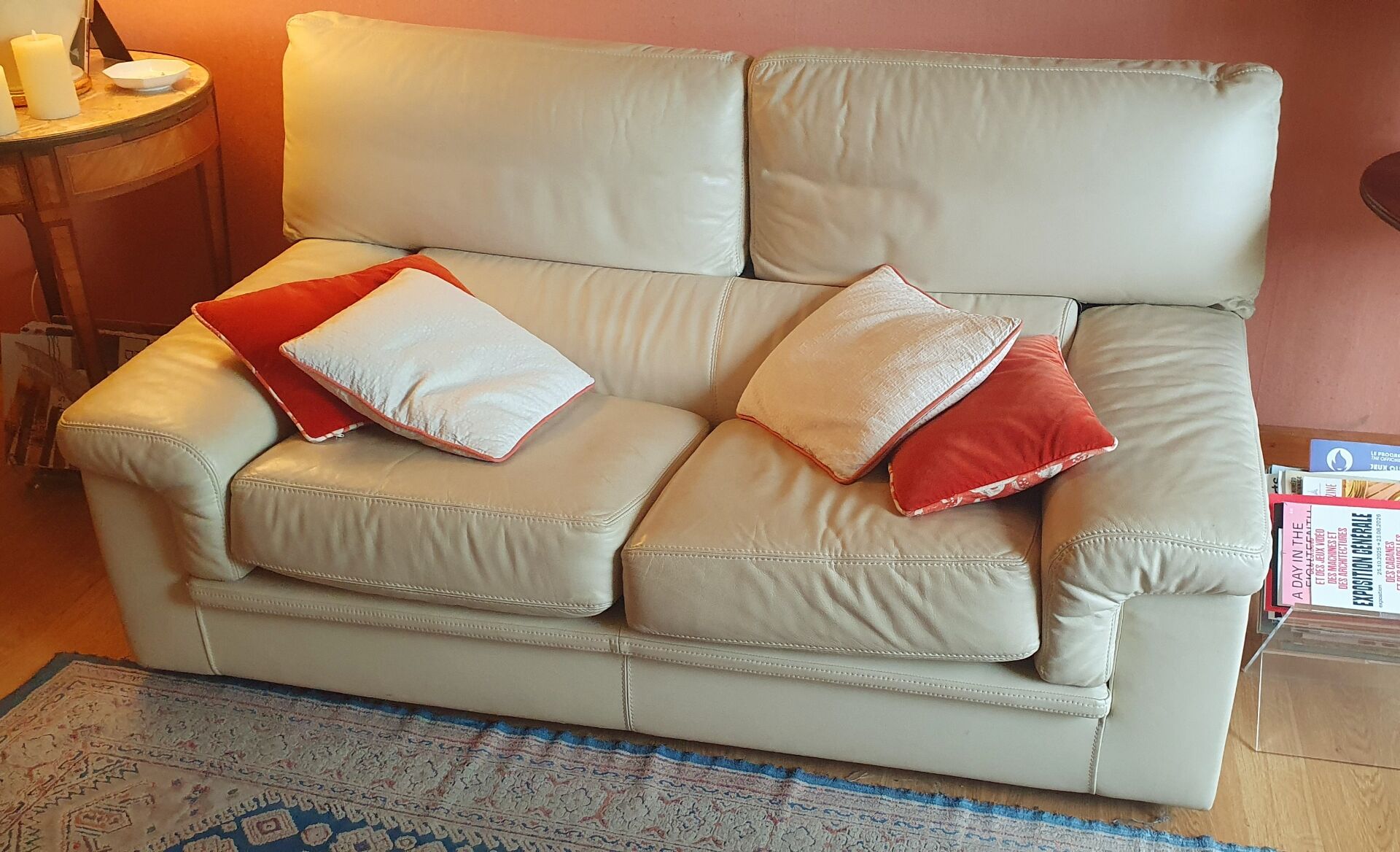 Two-seater convertible sofa bed in off-white leather by Ligne Roset.