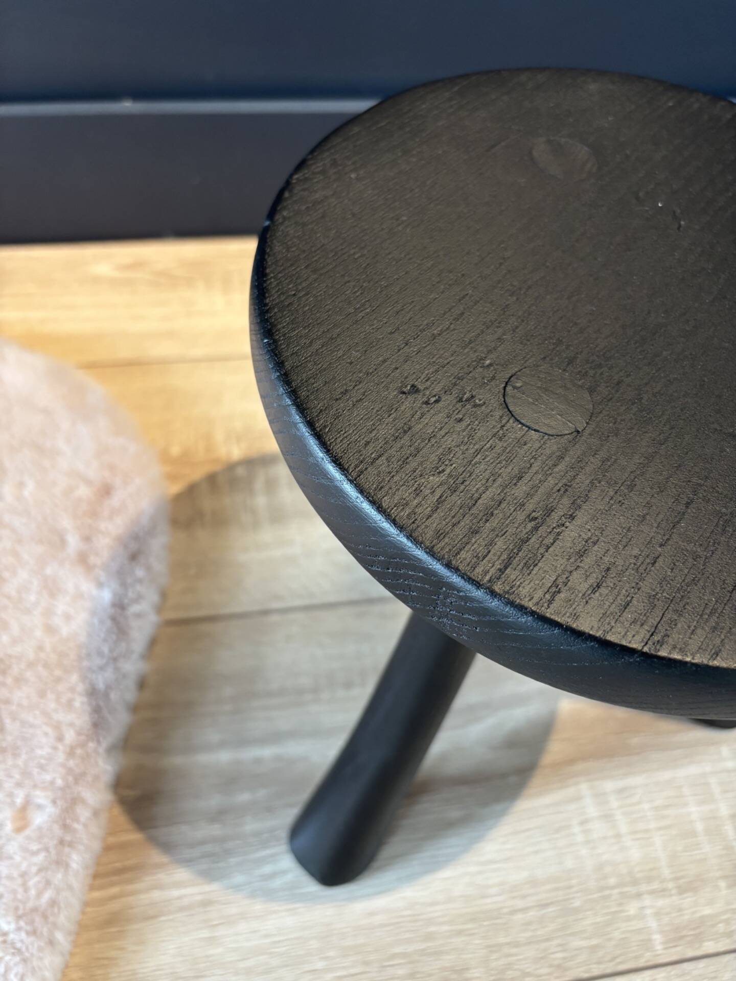 Small black wooden tripod stool