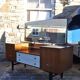 Mid-century hairdresser in brown teak and white with a mirror and brass legs.