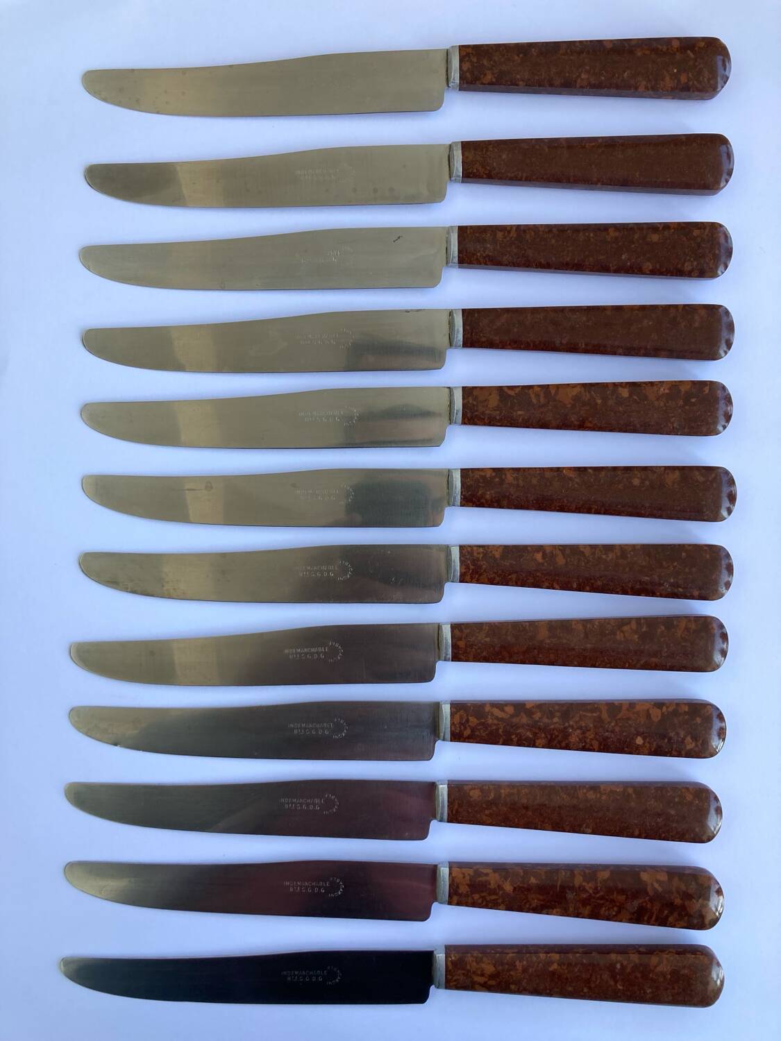 12 table knives stainless steel blade round ends / Bakelite handles with wood burl effect / 1950s