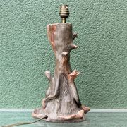 Lamp base in sculpted terracotta featuring birds, signed.