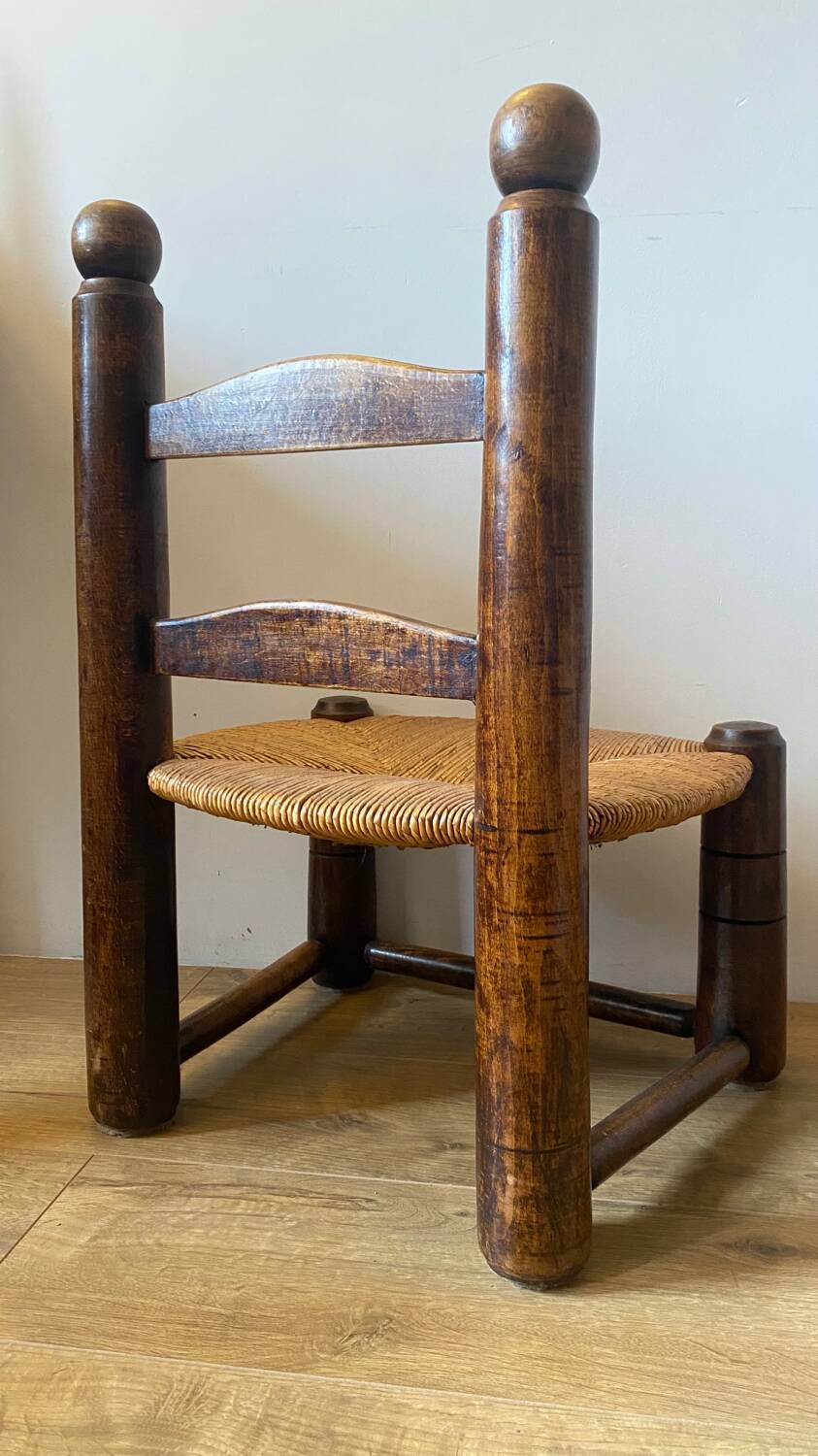 Low brutalist straw chair called fireplace chair