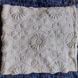 White bed throw with relief embroidery and floral patterns