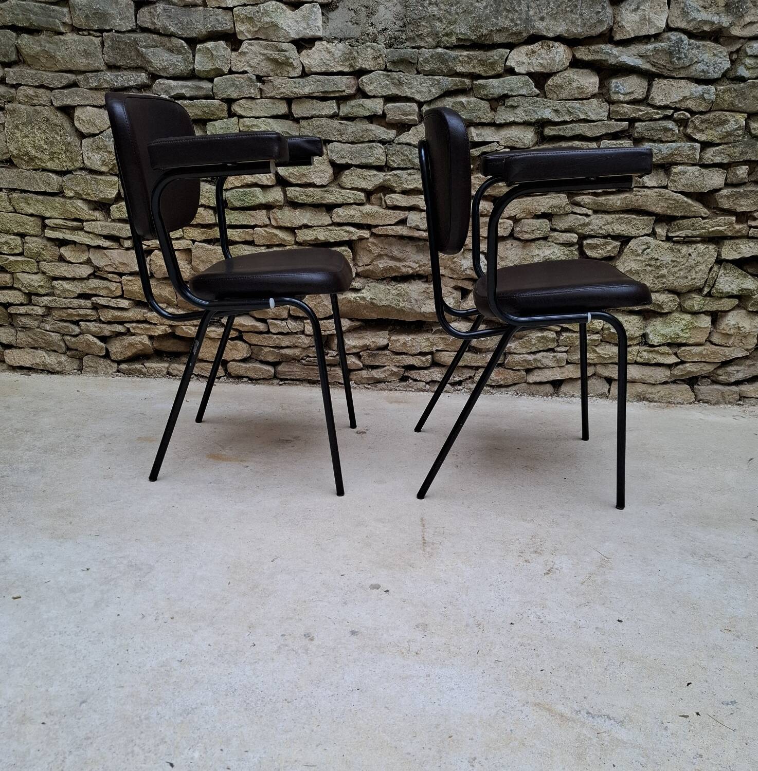 Brown faux leather armchairs