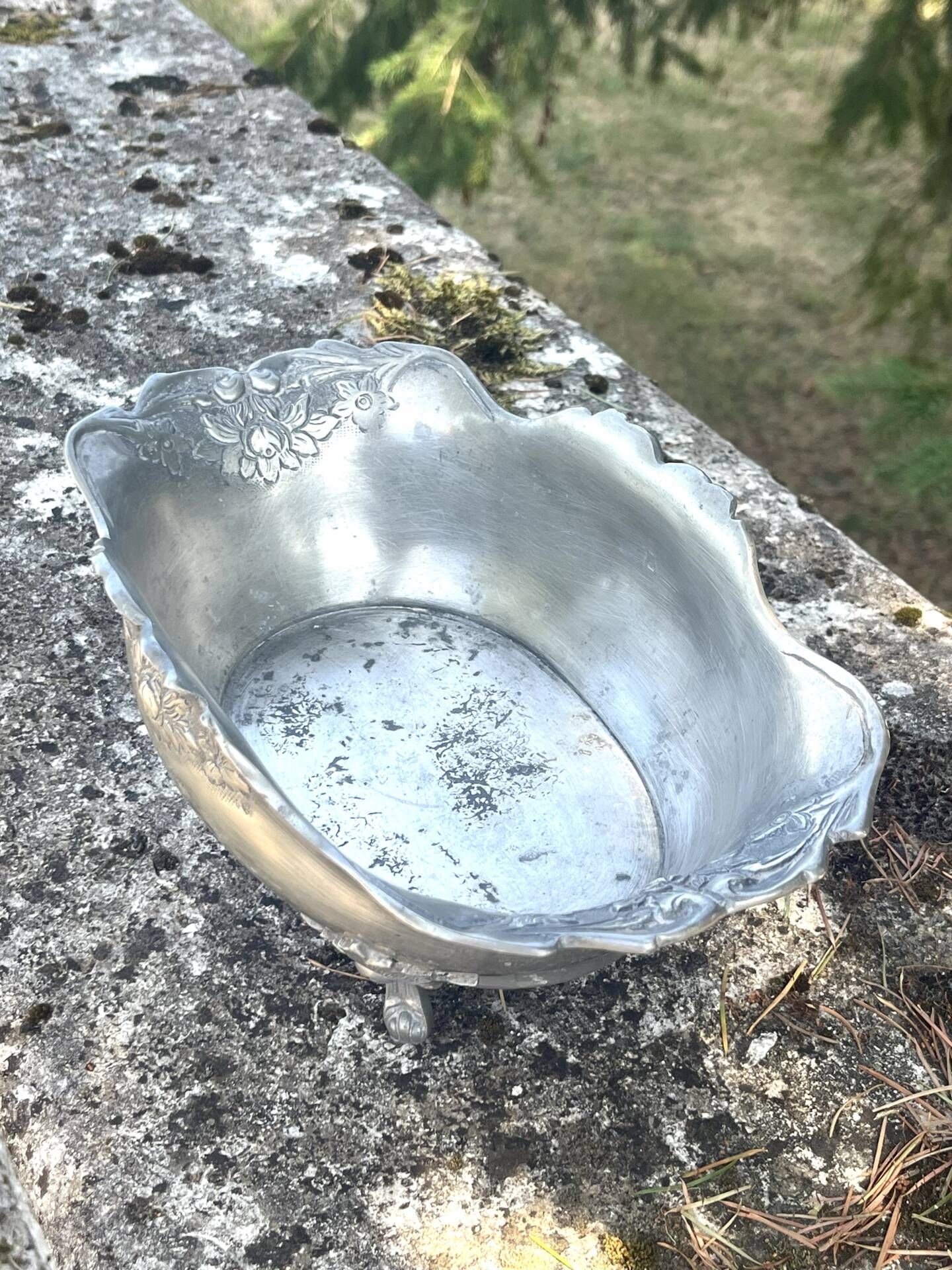 Footed pewter champagne cooler on claw feet with floral relief