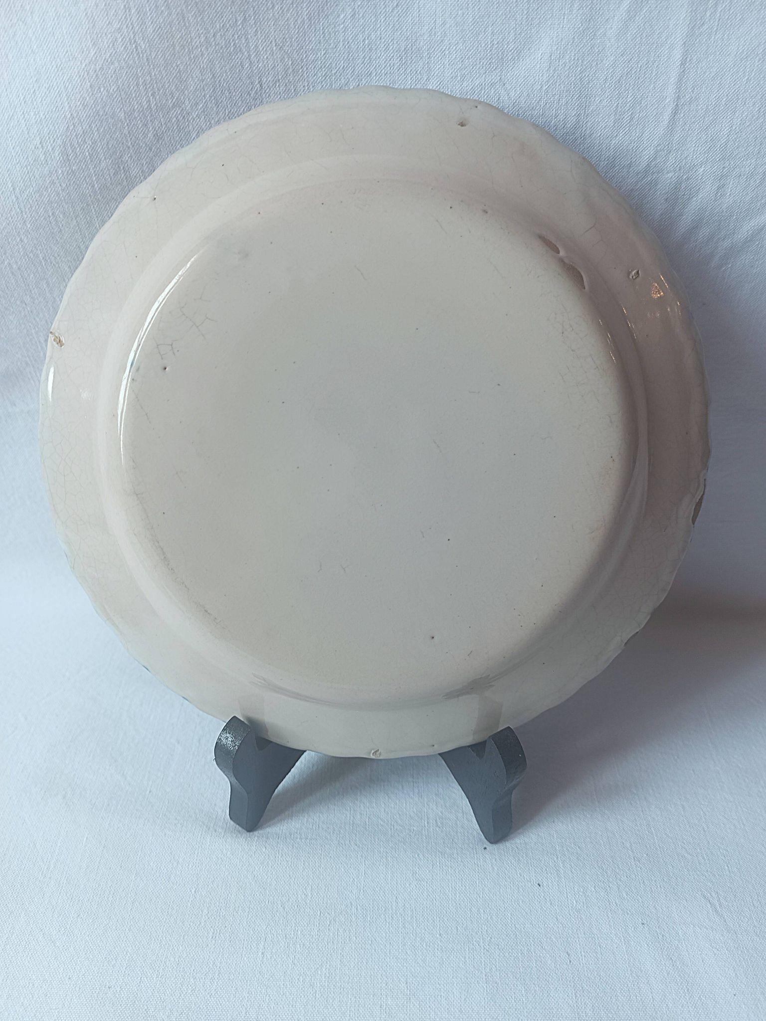 Pair of antique plates in popular earthenware with a floral basket decoration on the edge.