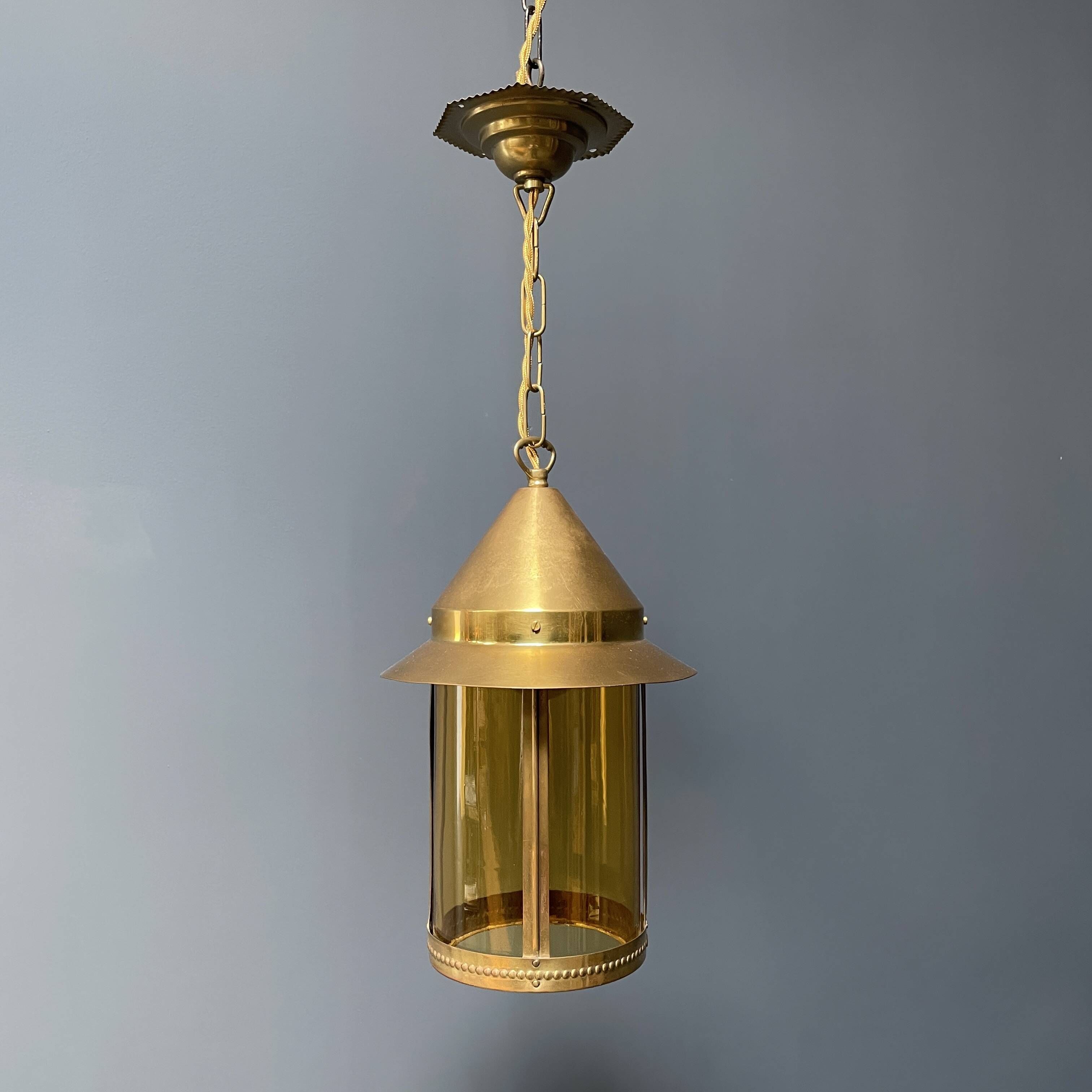 Brass lantern pendant lamp with yellow glass
