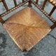Brutalist corner chair in turned wood with straw bobbins, 1960.