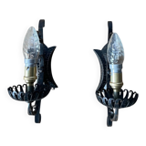 Vintage wrought iron wall lights in rustic gothic style.
