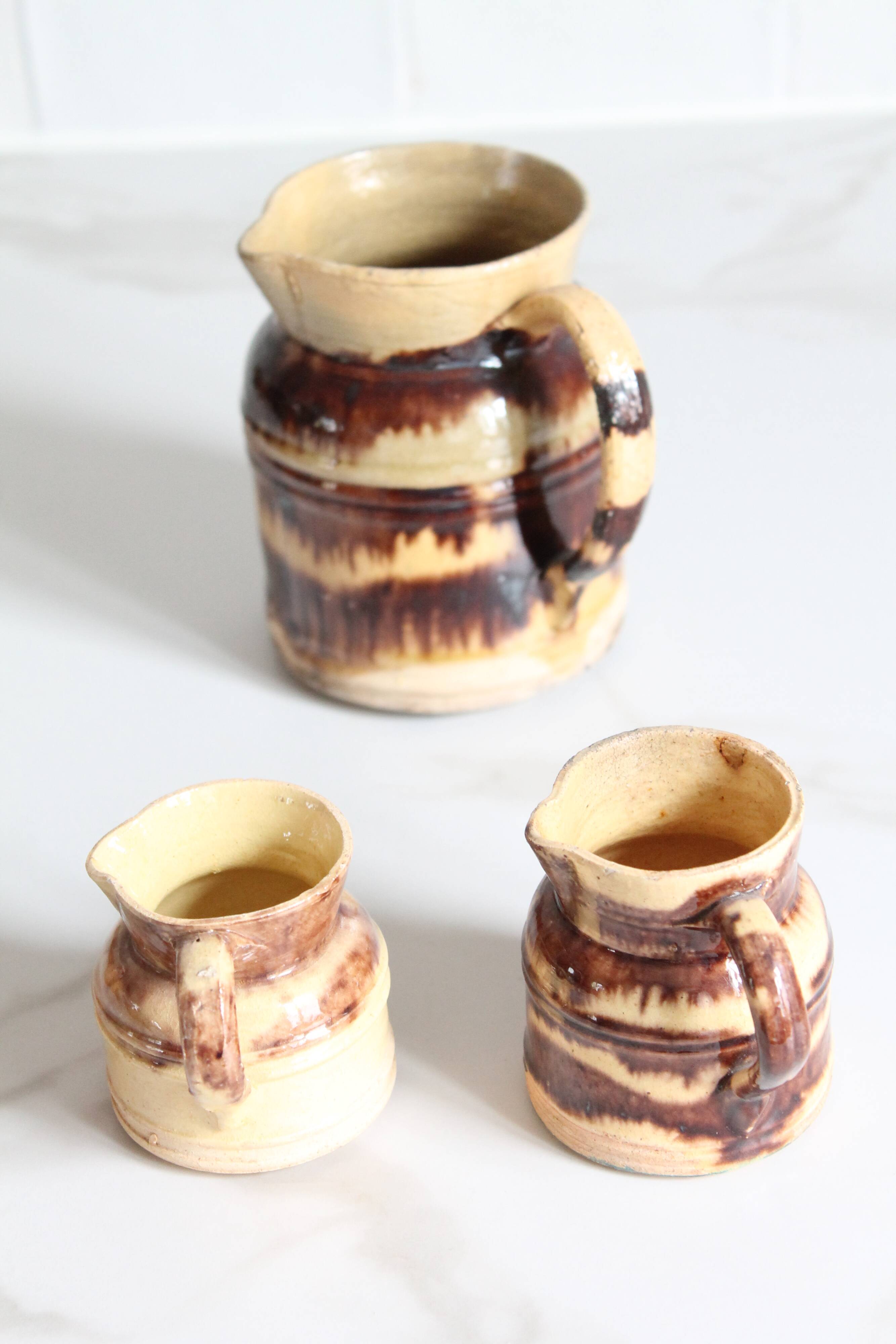 3 old bicoloured enamelled stoneware jugs