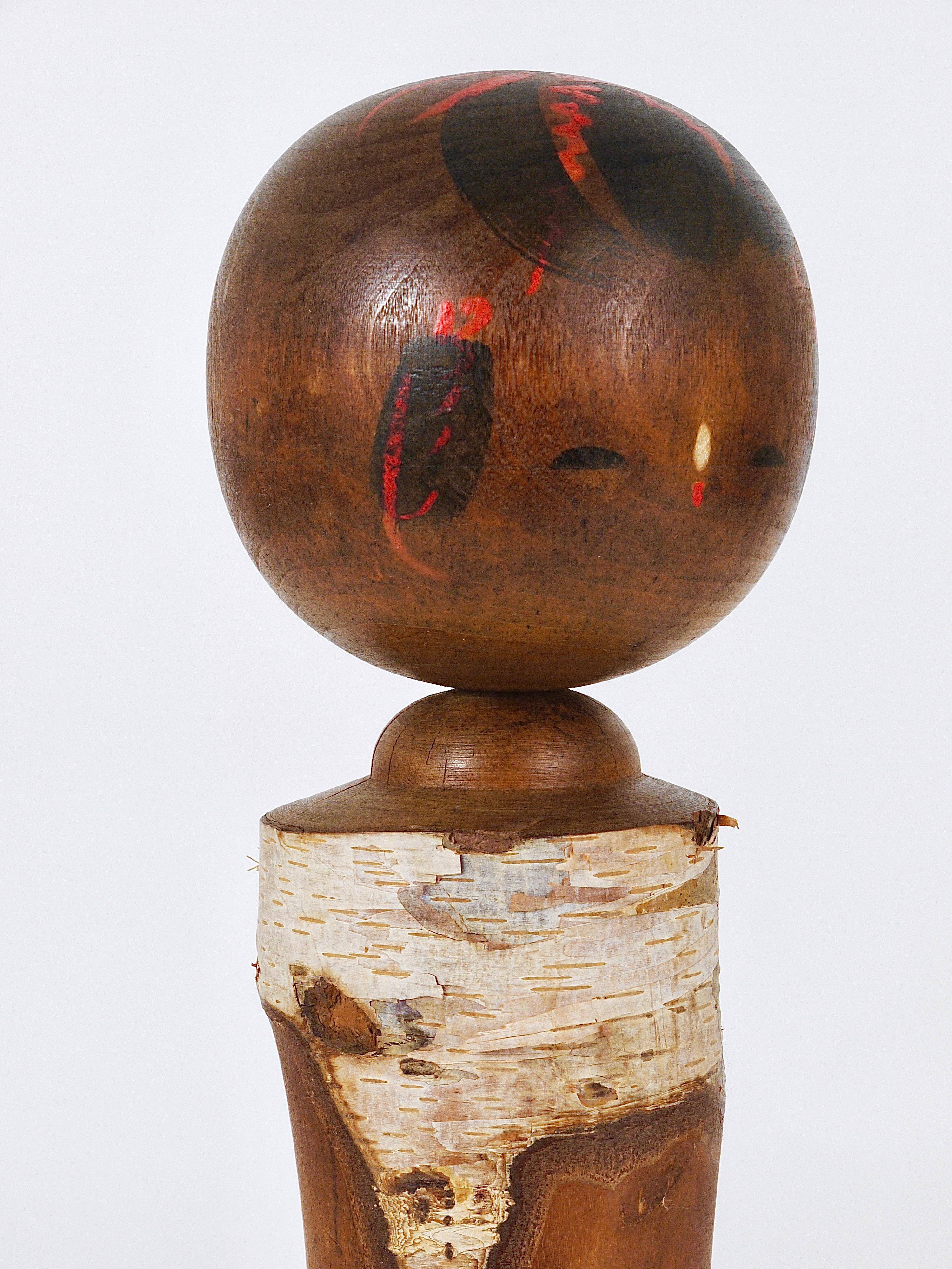 Decorative Kokeshi doll sculpture from northern Japan, hand-painted.