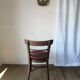 Set of 19 vintage wooden bistro chairs with red faux leather.