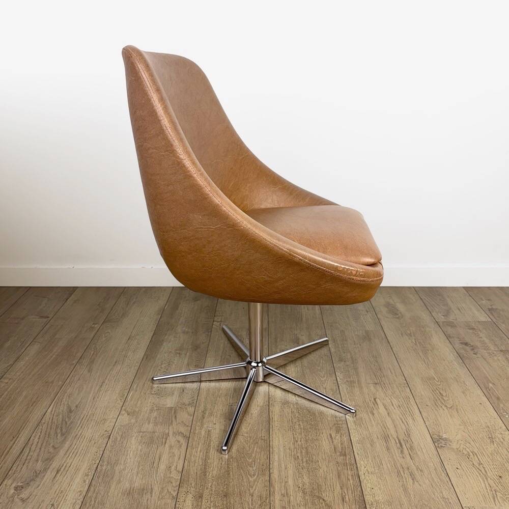 1970s swivel chair with faux leather shell and chrome.