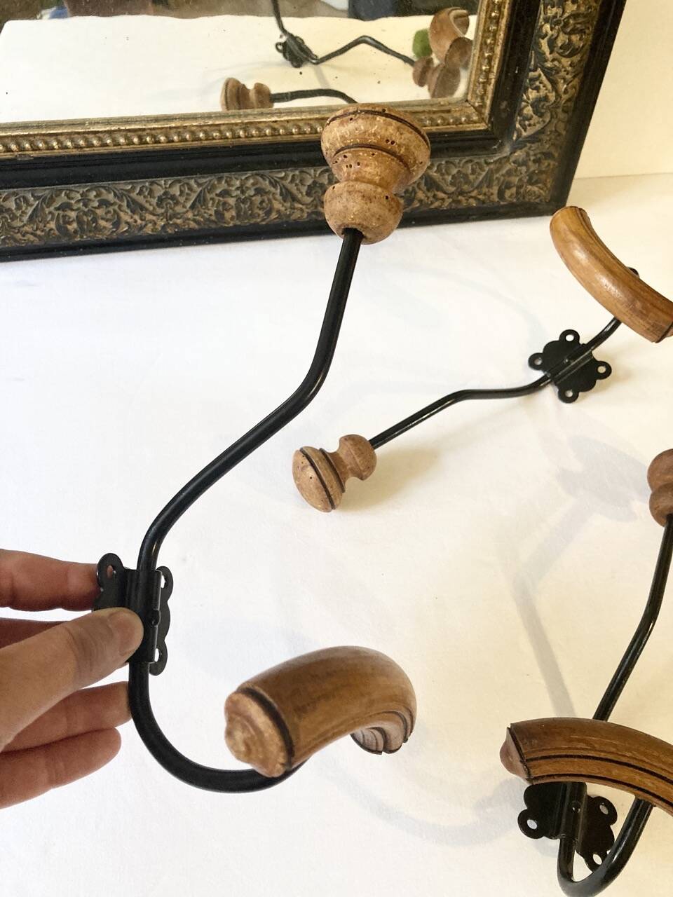 Trio of antique wooden and metal coat hooks