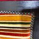 Art Deco armchair in multicolored striped fabric and its footrest
