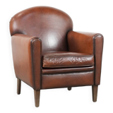 Sheepskin art deco design armchair with timeless and warm colours