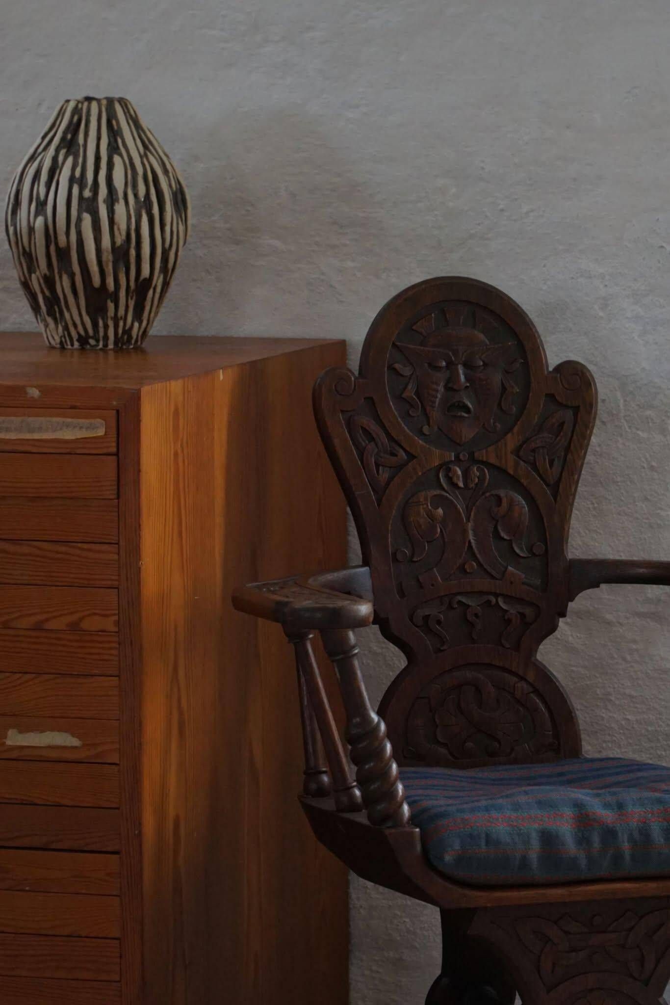 Scandinavian armchair in solid oak with cushion, folk art, early 19th century.
