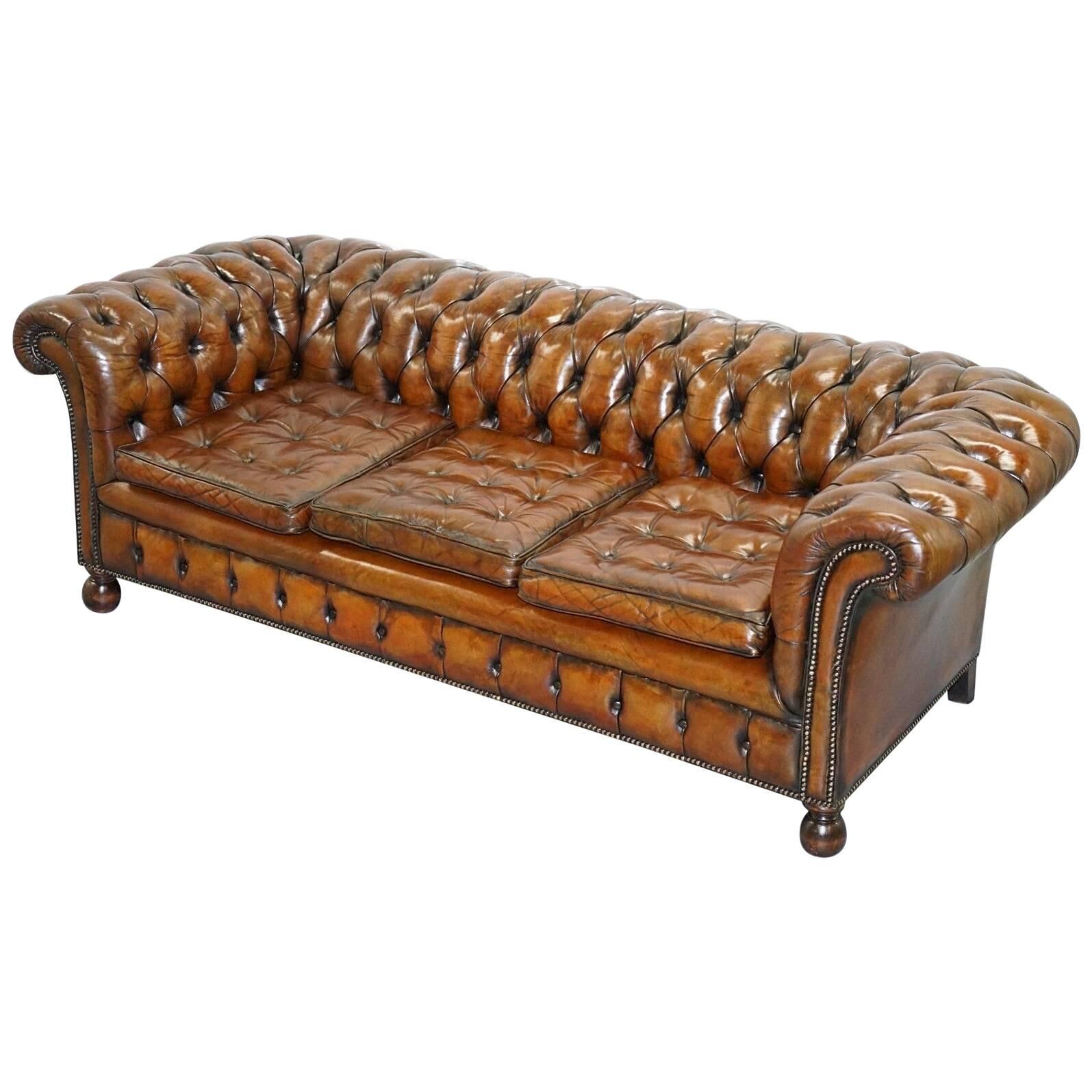 Restored vintage leather Chesterfield canapé in Thomas Chippendale style.