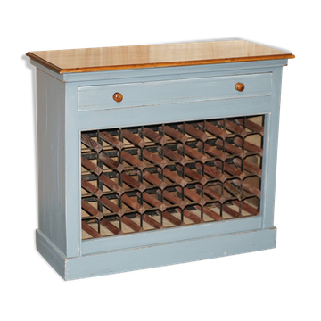 Vintage wooden furniture for 45 wine bottles with a drawer.