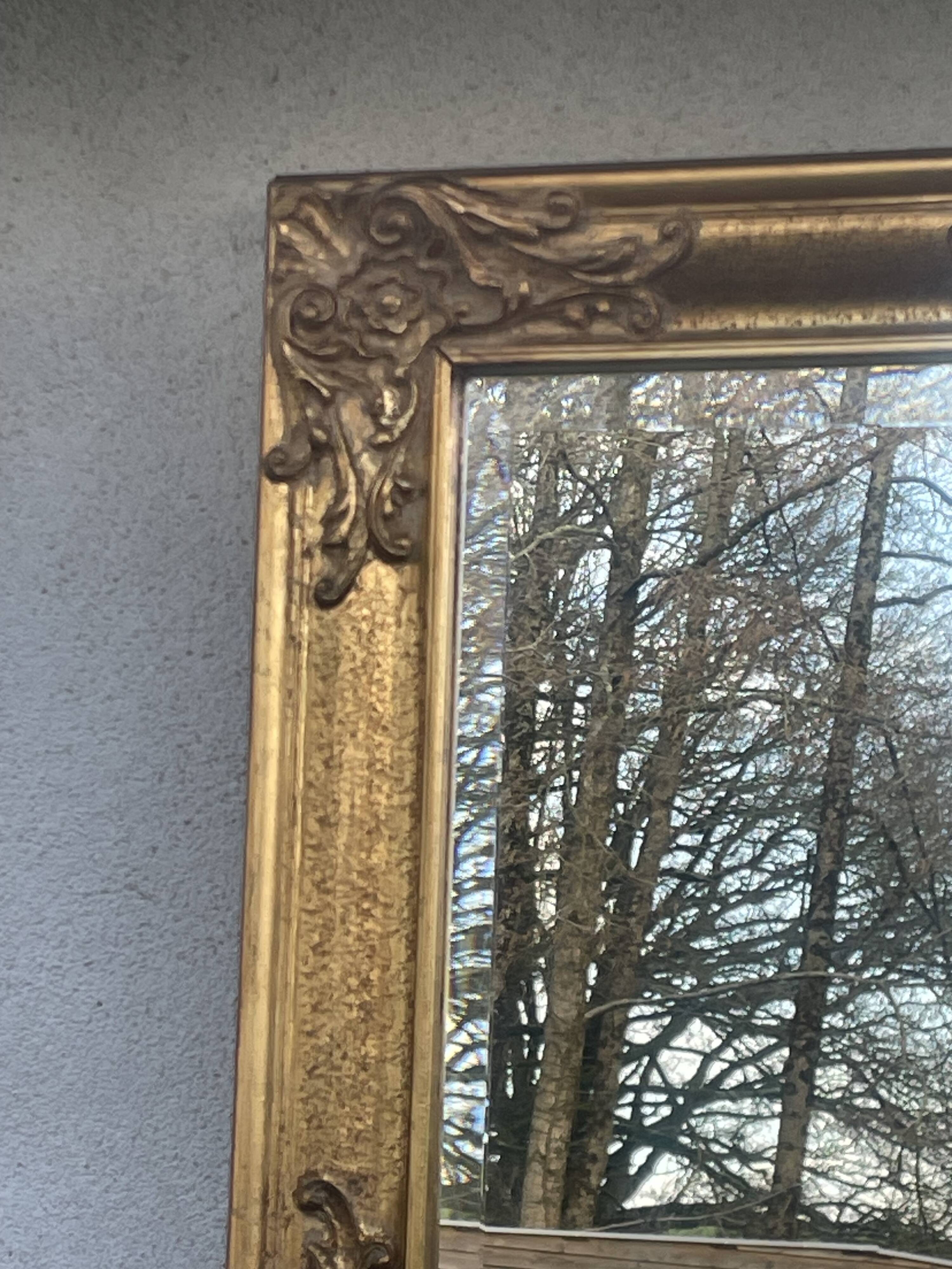 vintage bevelled mirror in rectangular shape, stucco and gilded wood in Louis XV baroque style
