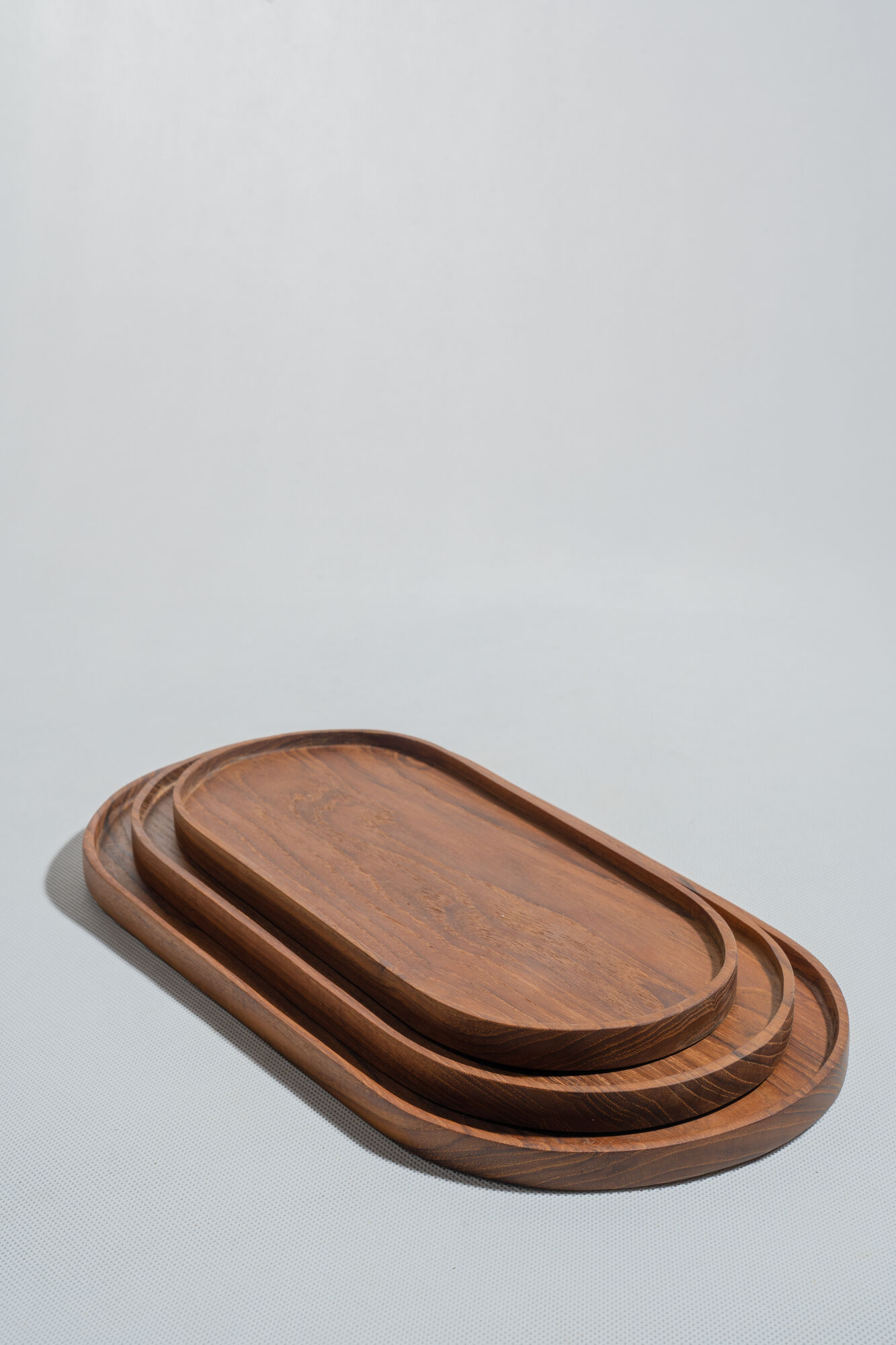 Trio of oval teak trays or cups