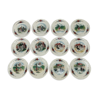12 plates of the Obernai earthenware décor service signed Henri Loux
