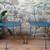 A pair of metal garden chairs