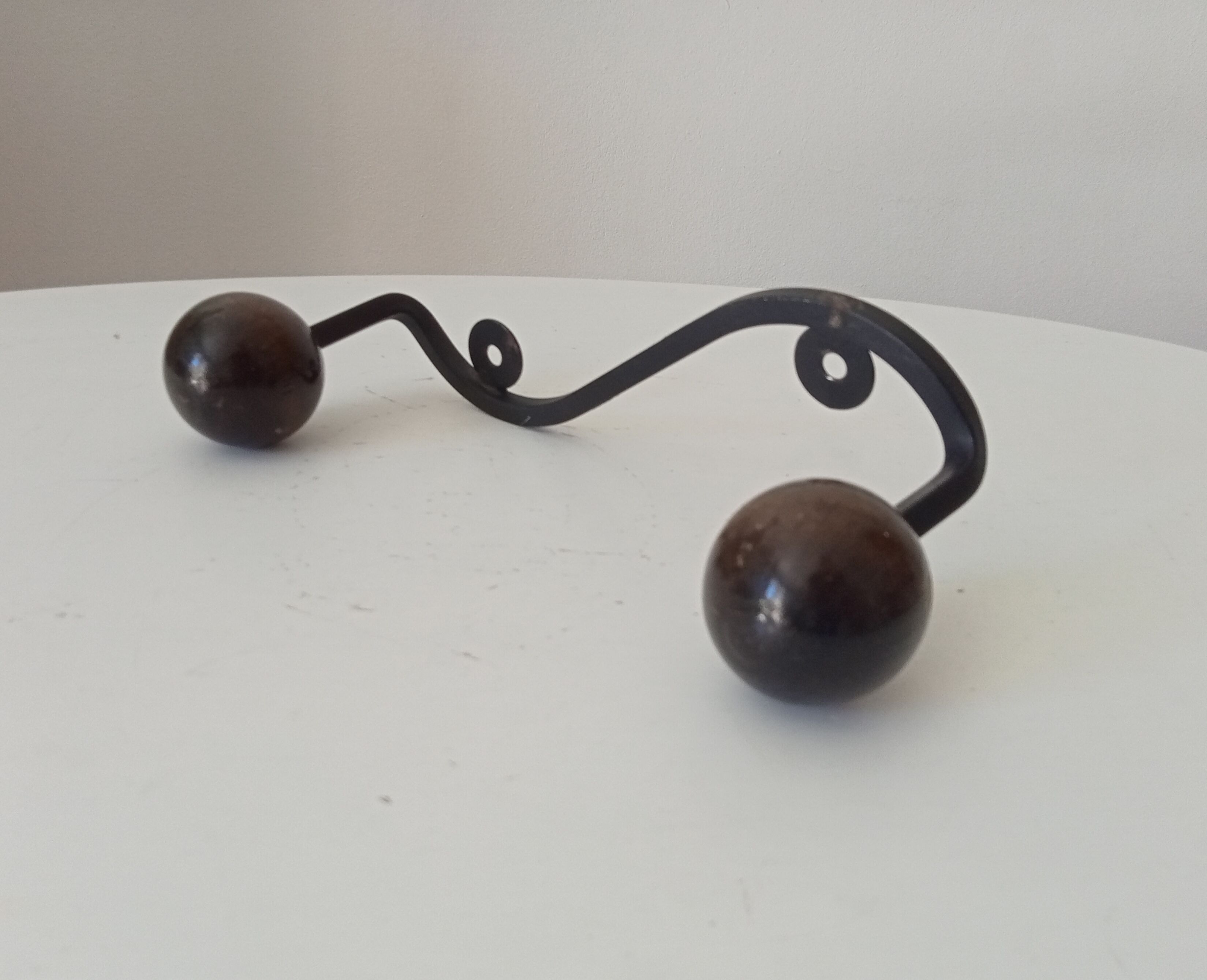 Wood and wrought iron ball coat rack from the 1950s.