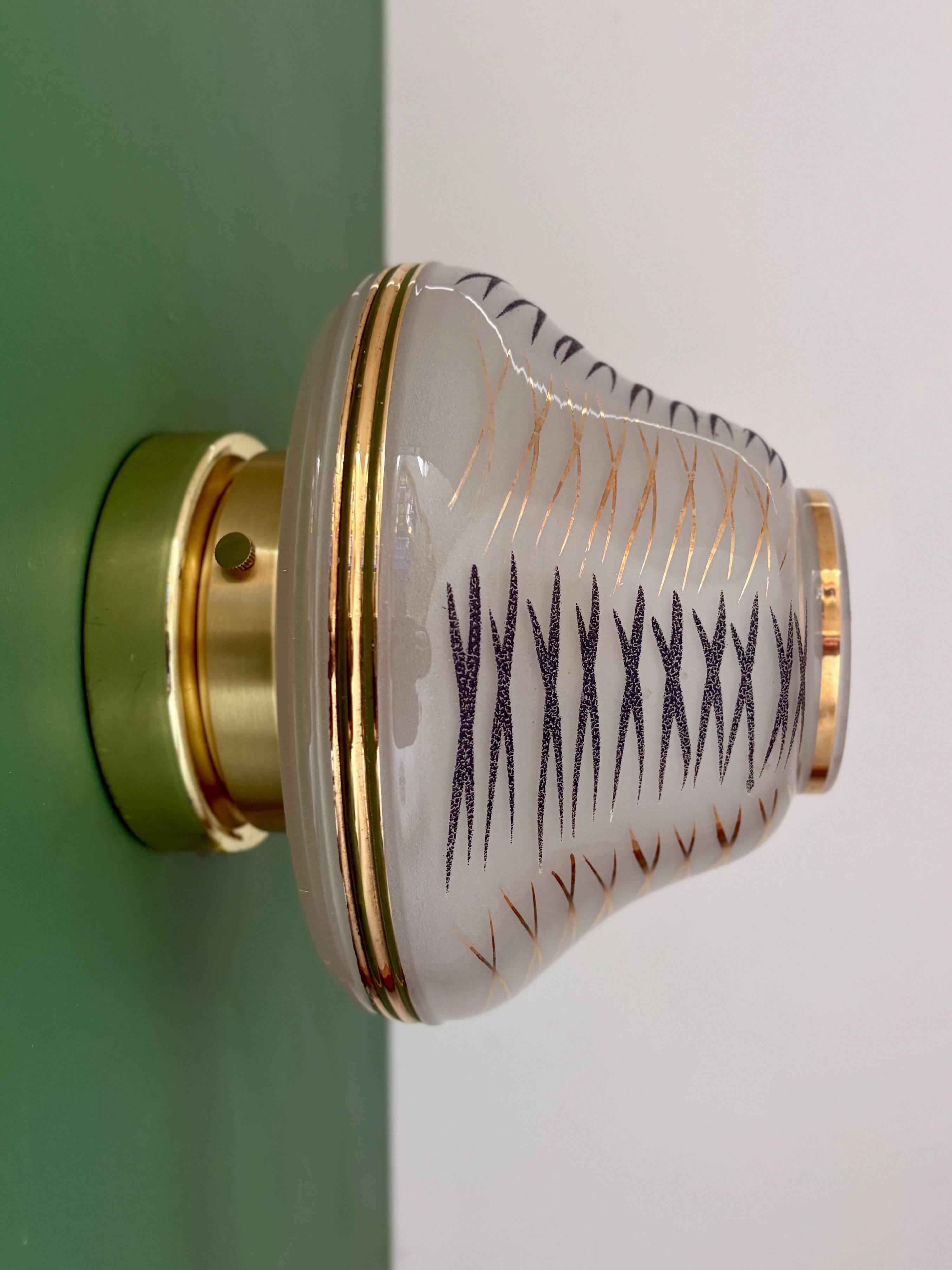 Vintage Art Deco globe wall/ceiling light in white, black, and gold glass.