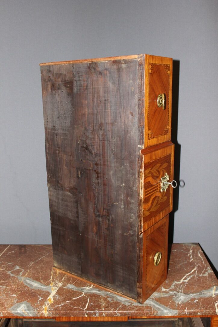 Louis XVI style chest of drawers with music attributes