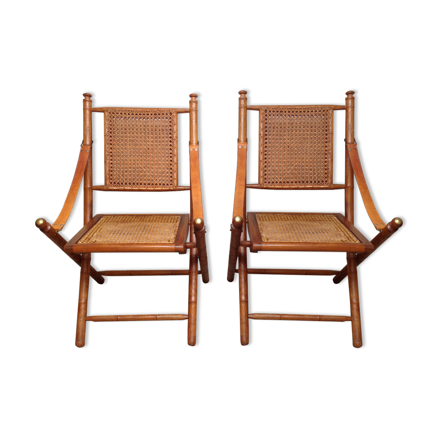 Pair of folding chairs in bamboo and caning, leather and brass